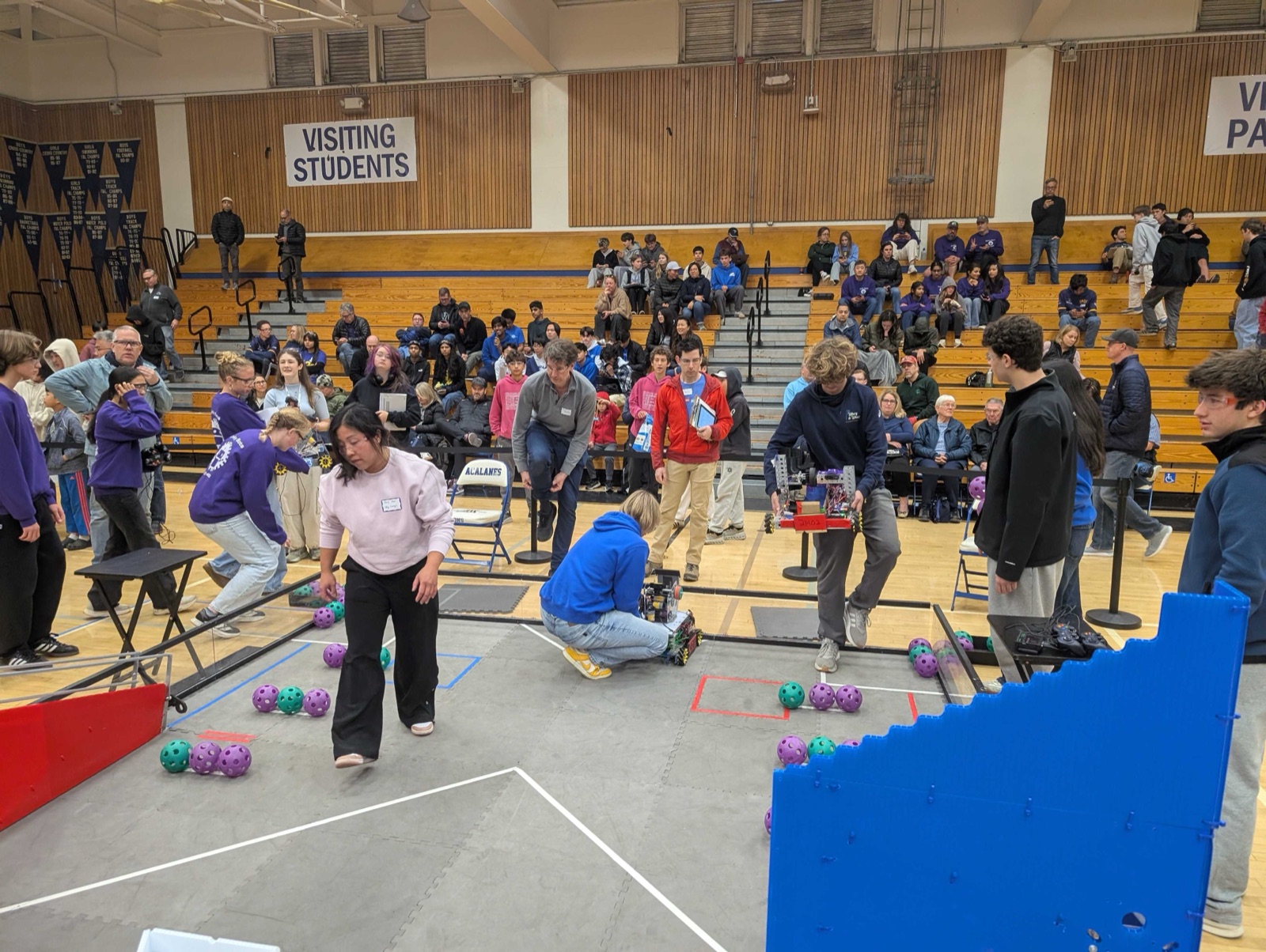 FTC team members working on their robot at a practice session.